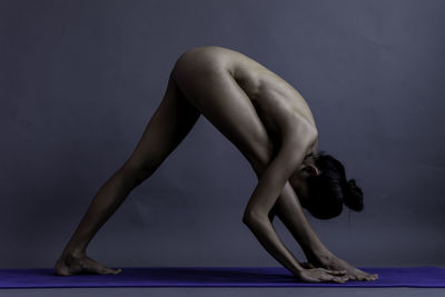 Midsection of woman dancing against white background