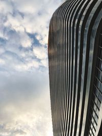 Low angle view of modern skyscraper against sky