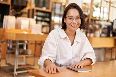 Portrait of young businesswoman working in office