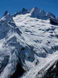 Scenic view of snowcapped mountains against clear sky