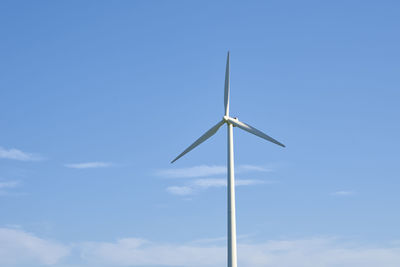 Wind turbine against blue sky. wind power energy concept. renewable energy for climate protection