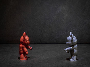 Toys on table against black background