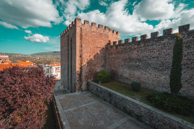 View of old building against cloudy sky