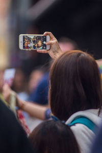 Rear view of woman photographing