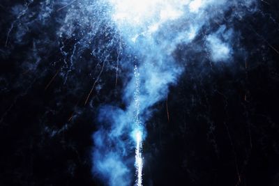 Low angle view of smoke against sky at night