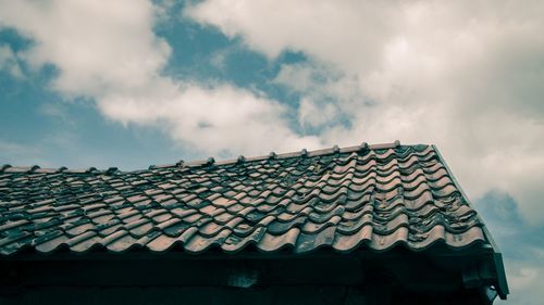 Low angle view of roof tiles against sky