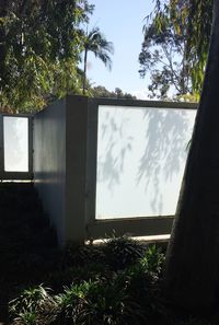 Plants and trees against sky seen through window