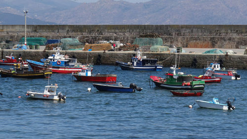 Boats moored in sea against sky