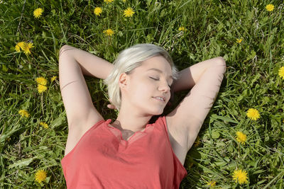 Midsection of woman lying down on grass