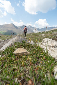 Man standing on field against sky
