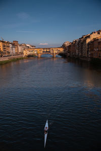 Bridge over river against buildings in city