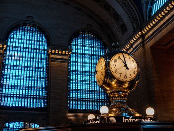 Low angle view of illuminated clock tower at grand centro station