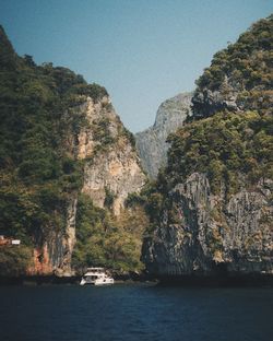 Scenic view of sea and mountains against sky