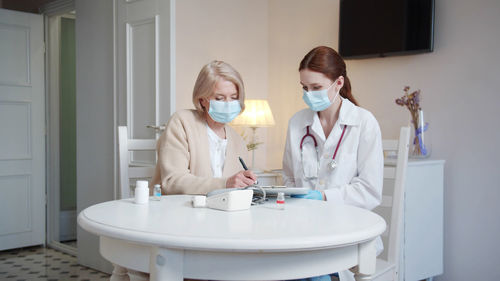 Female dentist examining chemical in laboratory