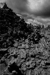 Close-up of rocks on landscape against sky