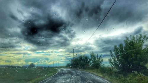 Wet road against sky during rainy season