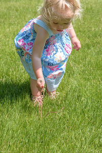 Girl standing on grassy field