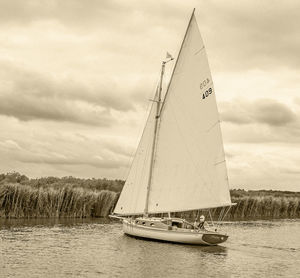 Sailboat sailing on pole against sky