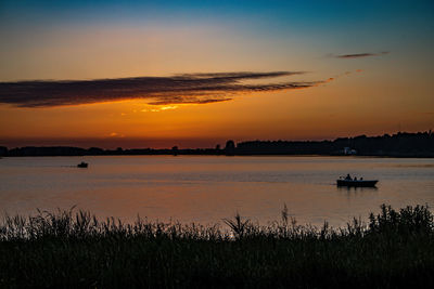 Scenic view of lake against sky during sunset