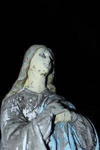 Low angle view of statue against black background