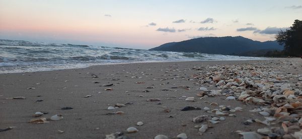 Scenic view of beach against sky during sunset