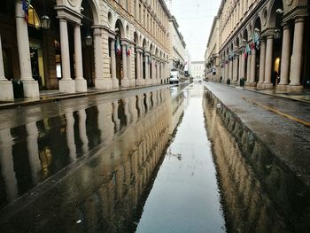 Reflection of buildings in puddle