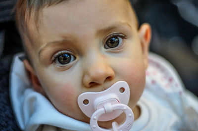Close-up portrait of toddler with pacifier