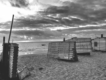 Lifeguard hut on beach against sky