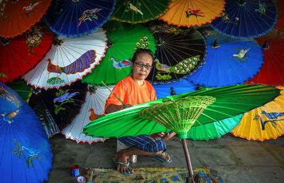 Man holding colorful umbrella