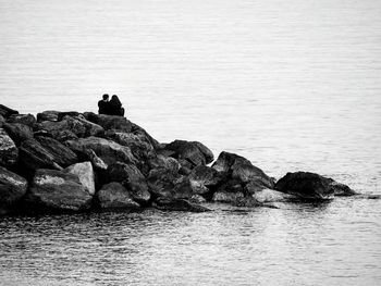 Rock formation in sea against sky