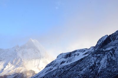 Scenic view of snowcapped mountains against clear sky