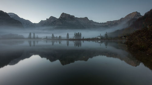 Scenic view of lake and mountains against sky