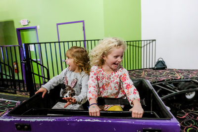 Two little girls laughing with joy on rollercoaster