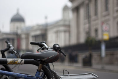 Close-up of bicycle on street in city