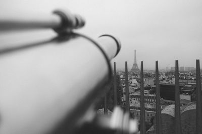 Distant image eiffel tower with hand-held telescope in foreground