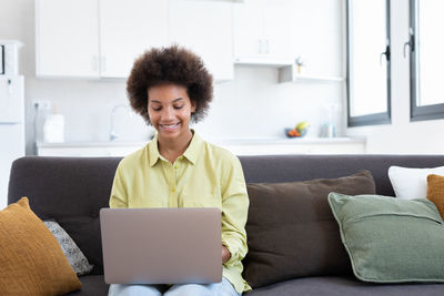 Young woman using laptop at home
