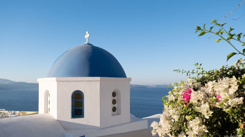 Church by sea against clear sky