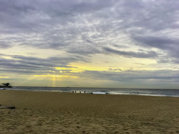 Scenic view of beach against sky during sunset