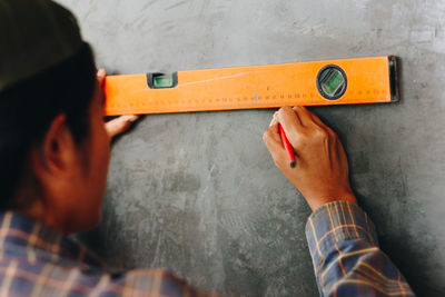 Man marking on wall