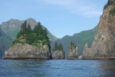 Scenic view of sea and mountains against sky