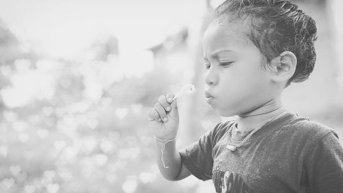 Close-up of boy blowing bubbles