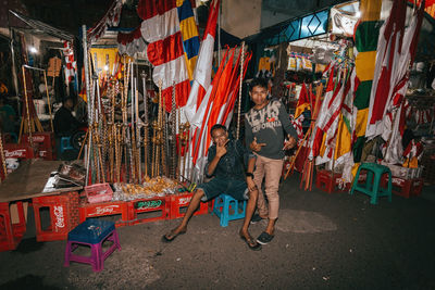 Full length of people standing at market stall