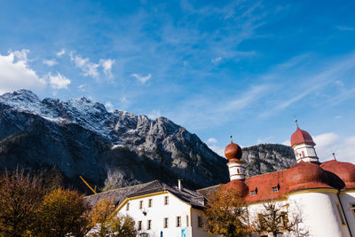 St. batholomä church against sky with mountain range in background