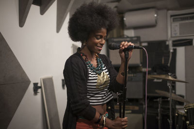 Singer performing in a recording studio