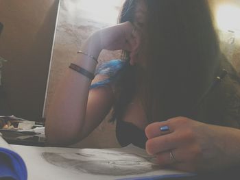 Close-up of woman holding hands at home