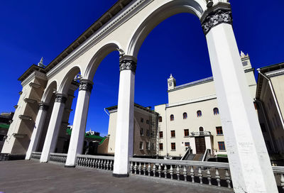 Low angle view of building against clear blue sky