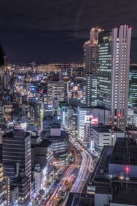 High angle view of city lit up at night