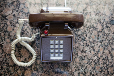 Directly above view of old-fashioned telephone on table