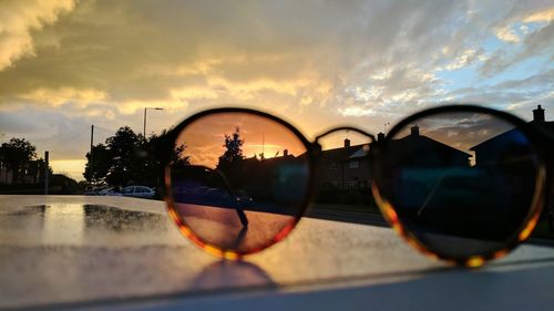 Close-up of sunglasses on side-view mirror