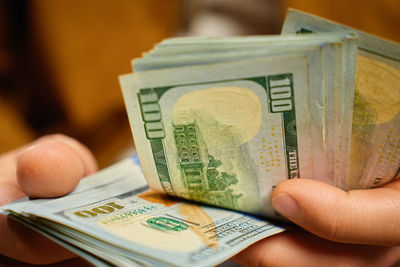 Cropped hand holding paper currency